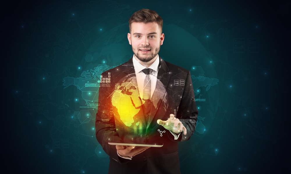 Spectacled businessman with global hologram concept and tablet on his hand